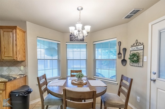 4910 Coyote Run, Abilene, TX 79602 - dining area featuring a chandelier, baseboards, and light tile patterned floors