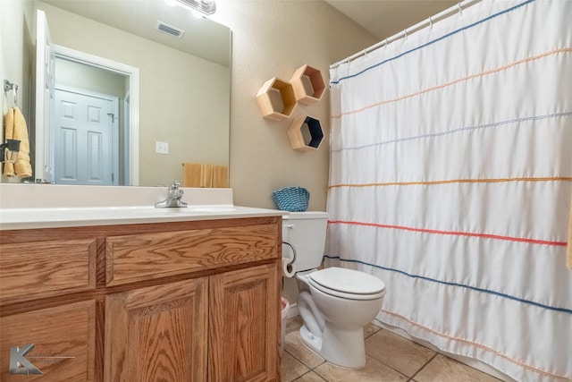 4910 Coyote Run, Abilene, TX 79602 - full bathroom with tile patterned floors, toilet, vanity, and a shower with shower curtain