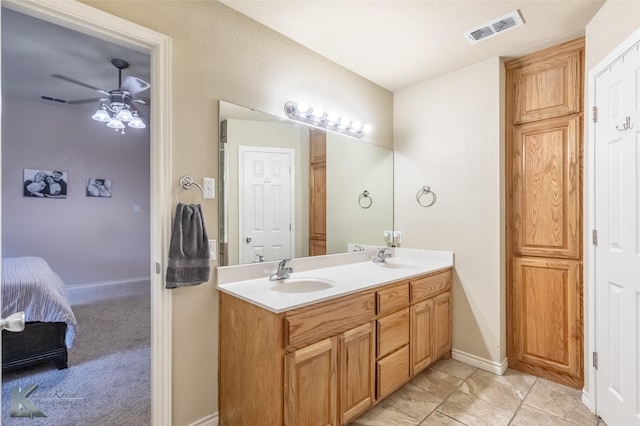 4910 Coyote Run, Abilene, TX 79602 - ensuite bathroom featuring ceiling fan, double vanity, and baseboards