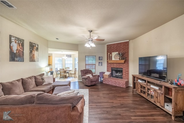 4910 Coyote Run, Abilene, TX 79602 - living room featuring ceiling fan, dark wood-style floors, and a brick fireplace