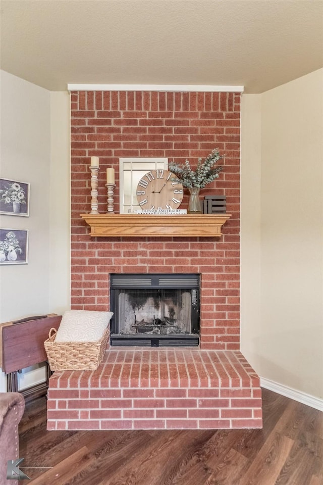 4910 Coyote Run, Abilene, TX 79602 - detailed view of a fireplace, wood finished floors, and baseboards