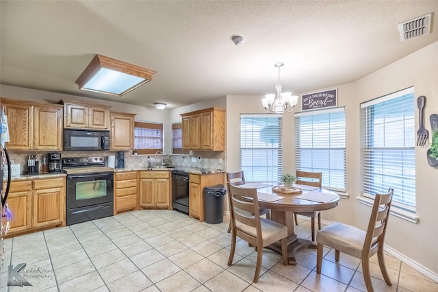 4910 Coyote Run, Abilene, TX 79602 - kitchen featuring black appliances, a chandelier, tasteful backsplash, light tile patterned floors, and a sink