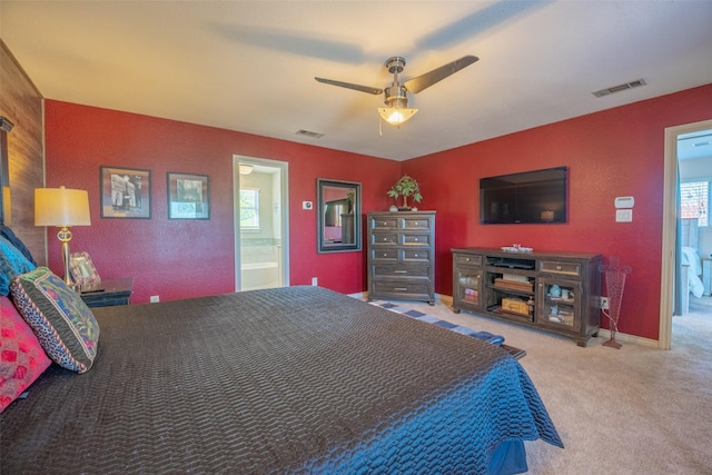 carpeted bedroom with a ceiling fan and visible vents