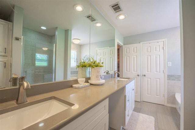 bathroom featuring a shower stall, visible vents, and a sink