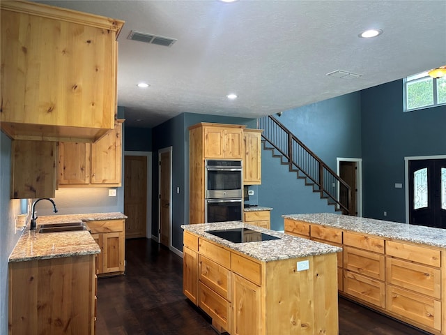 209 E Meadows St, Saint Jo, TX 76265 - kitchen featuring a sink, stainless steel double oven, light brown cabinets, black electric stovetop, and recessed lighting