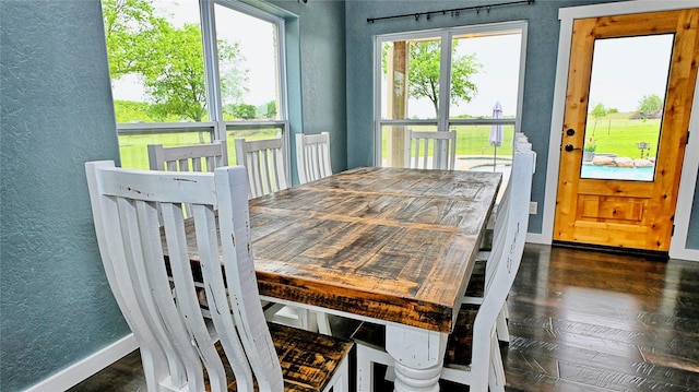 209 E Meadows St, Saint Jo, TX 76265 - dining area with a textured wall, baseboards, and dark wood-type flooring