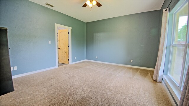 unfurnished bedroom with carpet flooring, baseboards, and visible vents