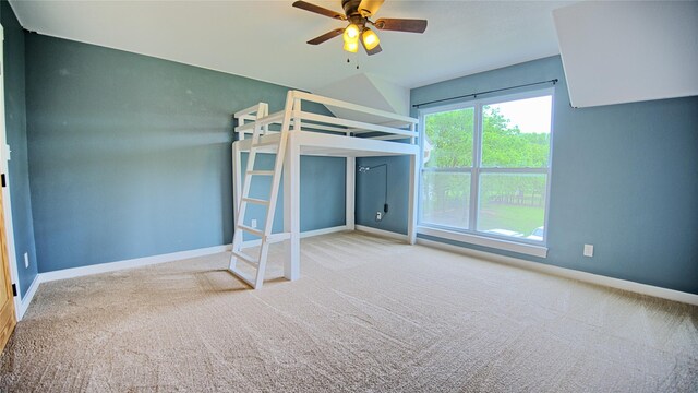 unfurnished bedroom with carpet floors, baseboards, and ceiling fan
