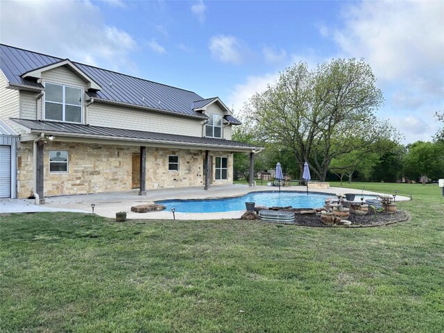 pool featuring a lawn and a patio