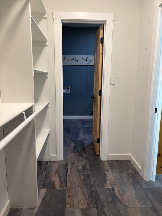 209 E Meadows St, Saint Jo, TX 76265 - walk in closet featuring dark stone finish floors