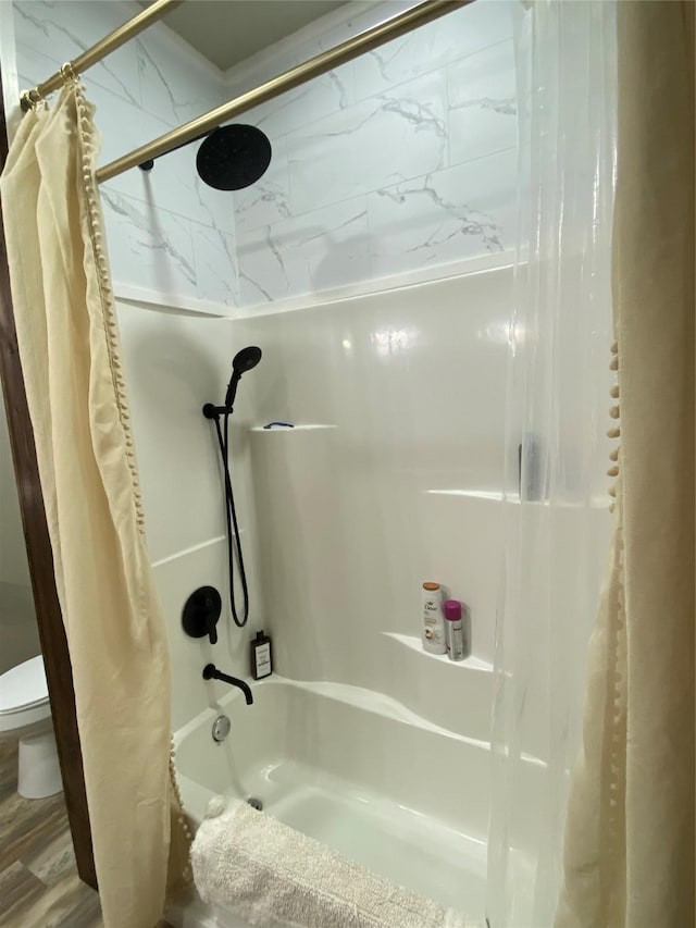 full bath with shower / bath combo with shower curtain, wood finished floors, and toilet