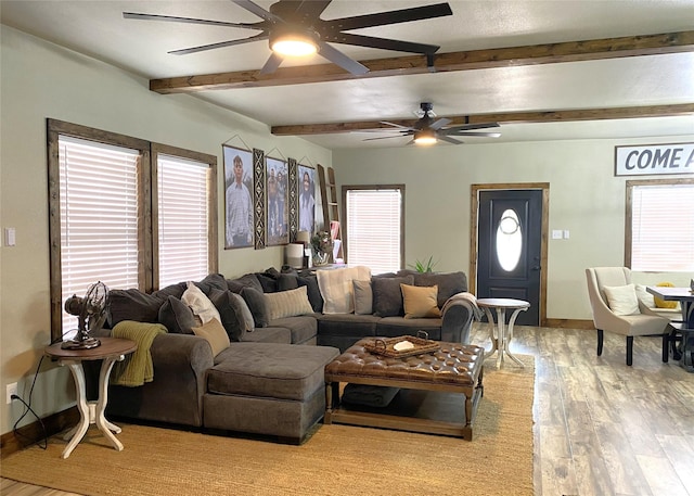 1609 Beech St, Cisco, TX 76437 - living room with a ceiling fan, beam ceiling, plenty of natural light, and wood finished floors