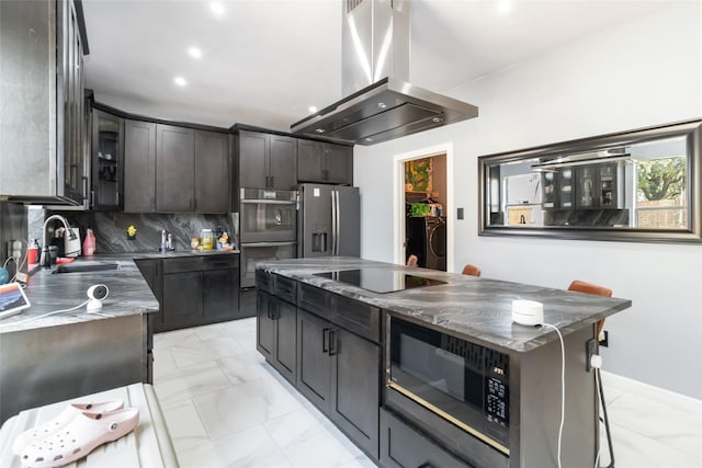 2409 Eisenhower Dr, Mckinney, TX 75071 - kitchen featuring a sink, marble finish floor, island exhaust hood, washing machine and dryer, and black appliances