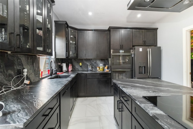 2409 Eisenhower Dr, Mckinney, TX 75071 - kitchen featuring dark brown cabinetry, backsplash, appliances with stainless steel finishes, a sink, and marble finish floor