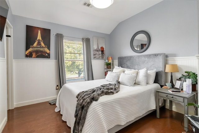 2409 Eisenhower Dr, Mckinney, TX 75071 - bedroom featuring visible vents, vaulted ceiling, wainscoting, wood finished floors, and baseboards