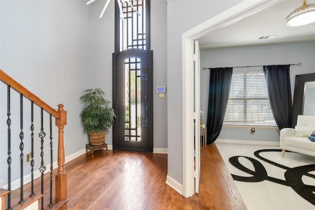 2409 Eisenhower Dr, Mckinney, TX 75071 - entryway with baseboards, stairs, wood finished floors, and visible vents