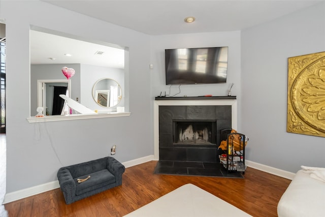 2409 Eisenhower Dr, Mckinney, TX 75071 - living area with baseboards, visible vents, wood finished floors, and a tile fireplace