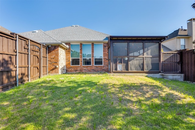 10401 Max Ln, Frisco, TX 75035 - back of property featuring brick siding, a sunroom, a fenced backyard, and a shingled roof