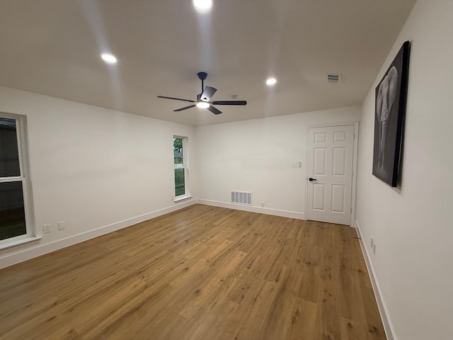 unfurnished room with ceiling fan, visible vents, baseboards, light wood finished floors, and recessed lighting