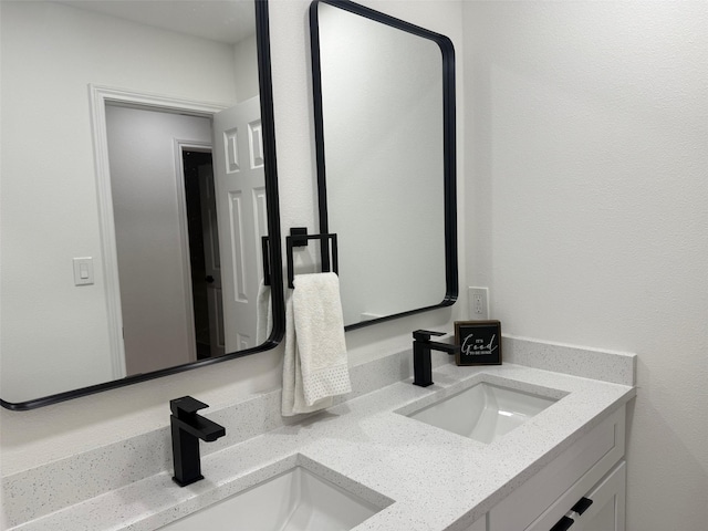 bathroom featuring double vanity and a sink