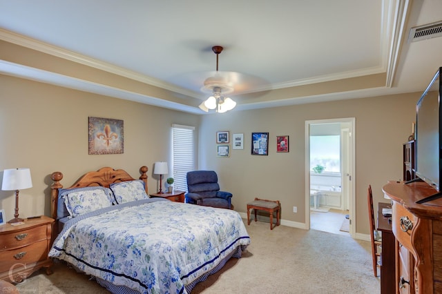 bedroom featuring a ceiling fan, light carpet, a tray ceiling, ornamental molding, and visible vents