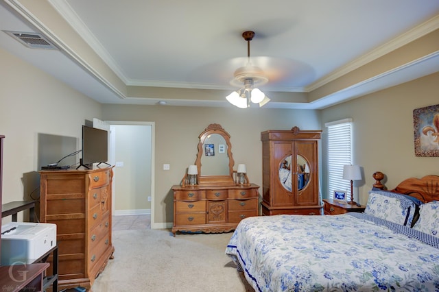 bedroom with carpet flooring, visible vents, a ceiling fan, crown molding, and a raised ceiling