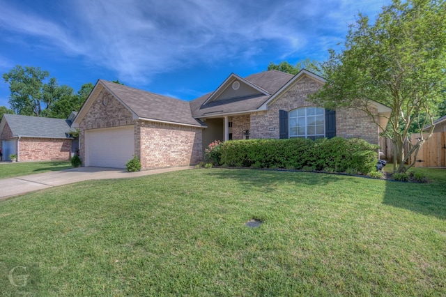 ranch-style home featuring a front lawn, driveway, fence, brick siding, and a garage