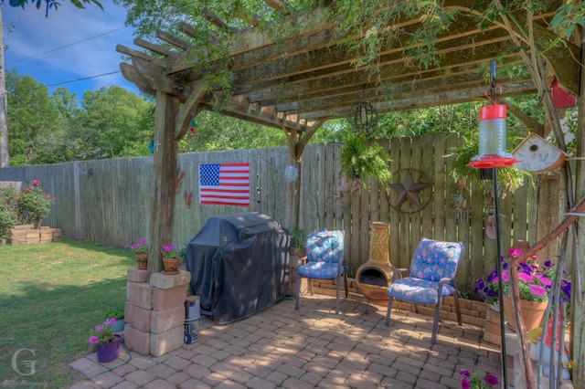 view of patio featuring a fenced backyard, a pergola, and area for grilling