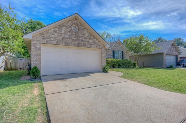 ranch-style home with brick siding, a front lawn, driveway, and an attached garage