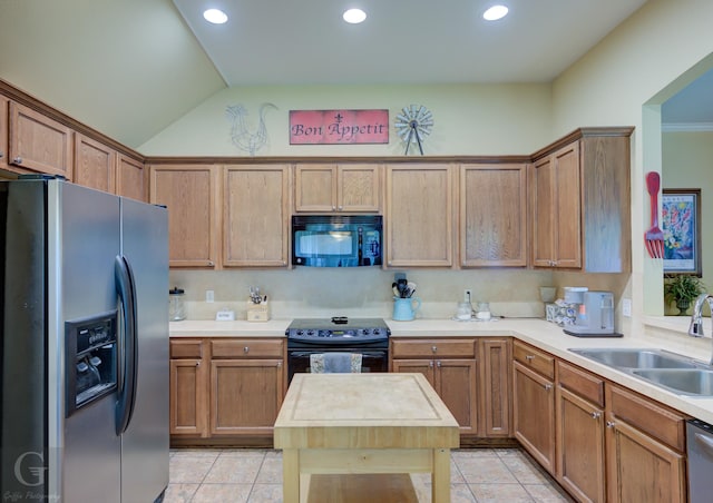 kitchen featuring black appliances, light tile patterned flooring, a sink, and light countertops