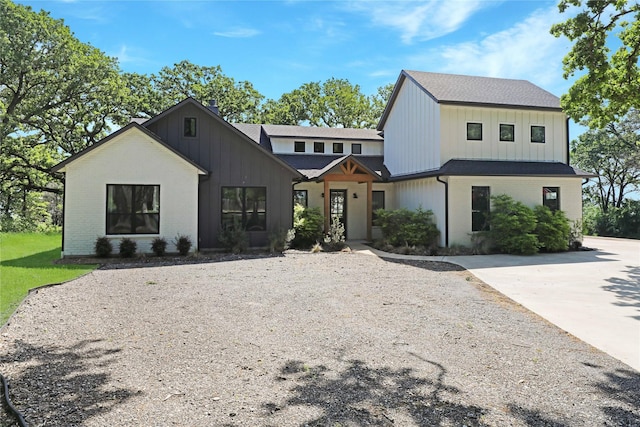 8919 Southern Shore Ct, Kemp, TX 75143 - modern farmhouse style home featuring brick siding, roof with shingles, and board and batten siding
