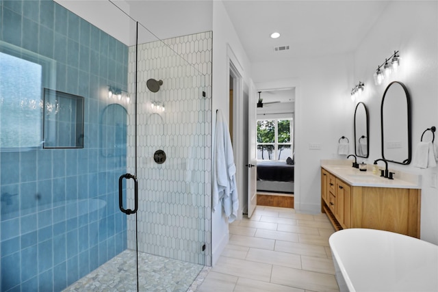 8919 Southern Shore Ct, Kemp, TX 75143 - ensuite bathroom with a ceiling fan, a sink, ensuite bathroom, a tile shower, and visible vents