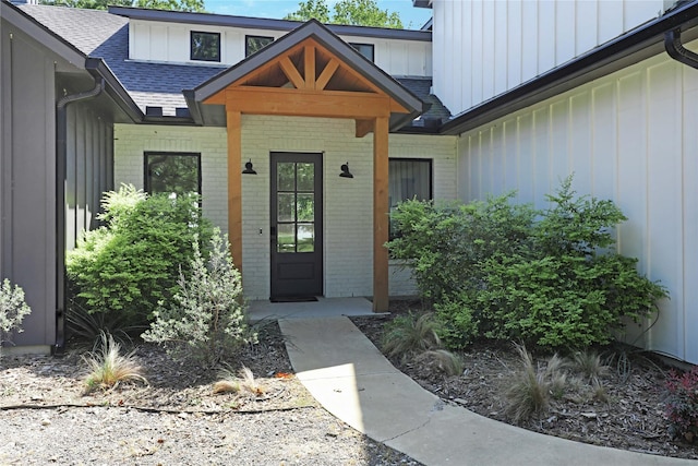 8919 Southern Shore Ct, Kemp, TX 75143 - property entrance with brick siding, board and batten siding, and a shingled roof