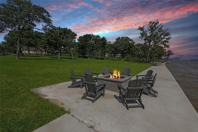 8919 Southern Shore Ct, Kemp, TX 75143 - patio terrace at dusk with a lawn and an outdoor fire pit