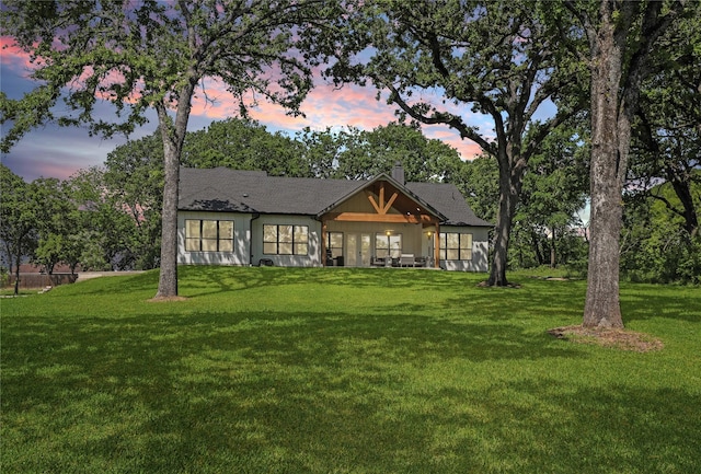 8919 Southern Shore Ct, Kemp, TX 75143 - back of property at dusk featuring a lawn