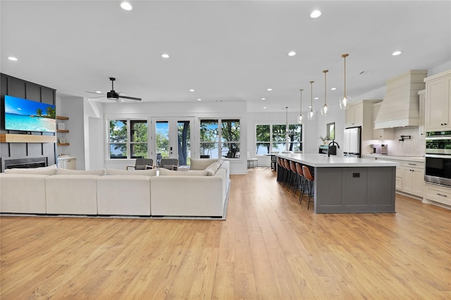 8919 Southern Shore Ct, Kemp, TX 75143 - living area featuring recessed lighting, a fireplace, light wood finished floors, and ceiling fan