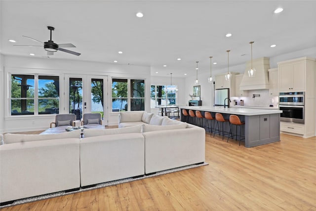 8919 Southern Shore Ct, Kemp, TX 75143 - living area with recessed lighting, light wood-style floors, a ceiling fan, and french doors