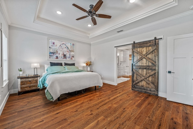 bedroom featuring multiple windows, ornamental molding, a tray ceiling, and visible vents