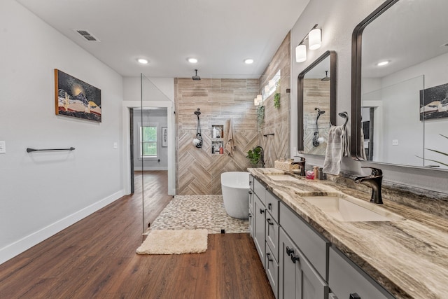 full bathroom featuring recessed lighting, walk in shower, visible vents, and a sink