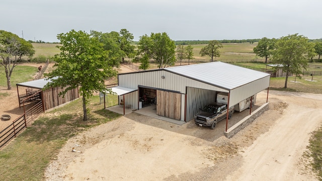 exterior space featuring a rural view and driveway
