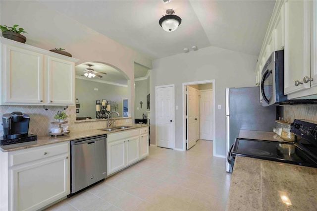 kitchen with white cabinets, appliances with stainless steel finishes, a sink, and tasteful backsplash