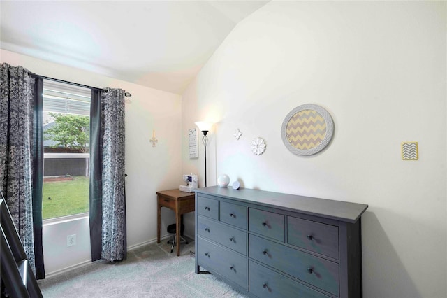 bedroom featuring baseboards, light colored carpet, and lofted ceiling