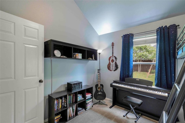 living area with baseboards, carpet flooring, and vaulted ceiling