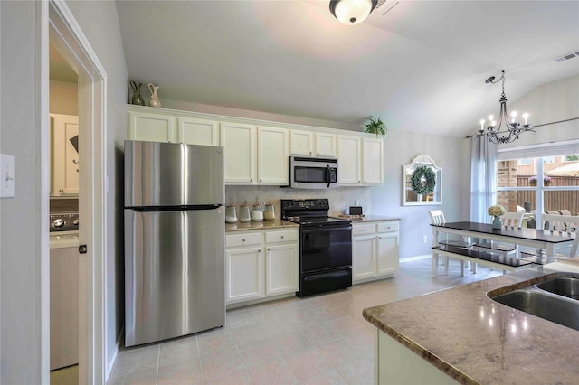 kitchen featuring white cabinets, light tile patterned floors, a notable chandelier, vaulted ceiling, and stainless steel appliances