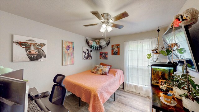 bedroom with a ceiling fan and wood finished floors