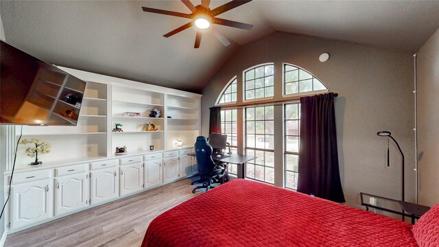bedroom featuring a ceiling fan, vaulted ceiling, and light wood-style flooring