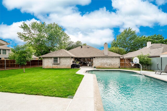view of swimming pool featuring a patio, a fenced backyard, a yard, and a fenced in pool