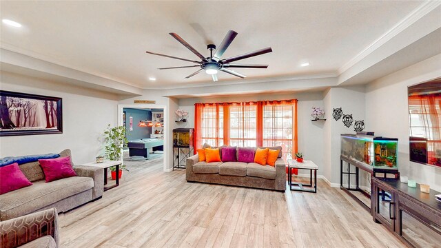 living area with recessed lighting, ornamental molding, light wood finished floors, and a healthy amount of sunlight