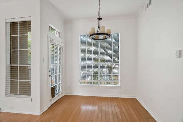 3311 Blackburn St Unit 104, Dallas, TX 75204 - unfurnished dining area with visible vents, light wood finished floors, baseboards, and ornamental molding