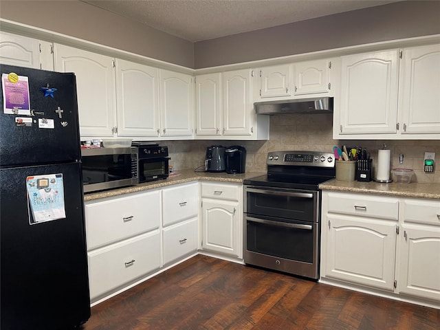 kitchen featuring tasteful backsplash, freestanding refrigerator, white cabinetry, range with two ovens, and under cabinet range hood